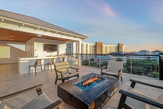 view of patio featuring a fire pit and an outdoor bar