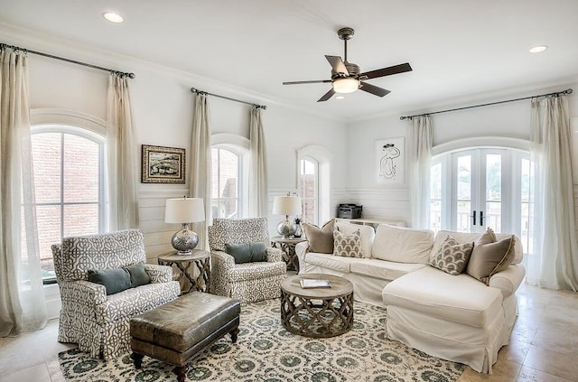 living room with french doors, ceiling fan, and a healthy amount of sunlight