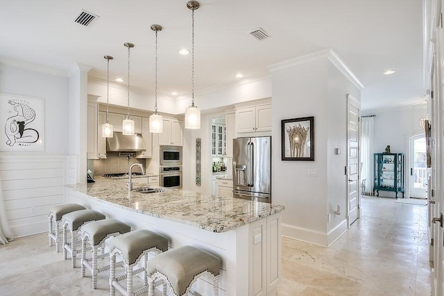 kitchen with stainless steel appliances, a kitchen breakfast bar, light stone counters, backsplash, and decorative light fixtures