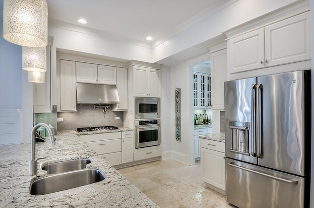 kitchen with appliances with stainless steel finishes, white cabinetry, pendant lighting, and sink