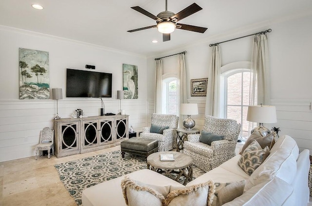 living room with ceiling fan and crown molding