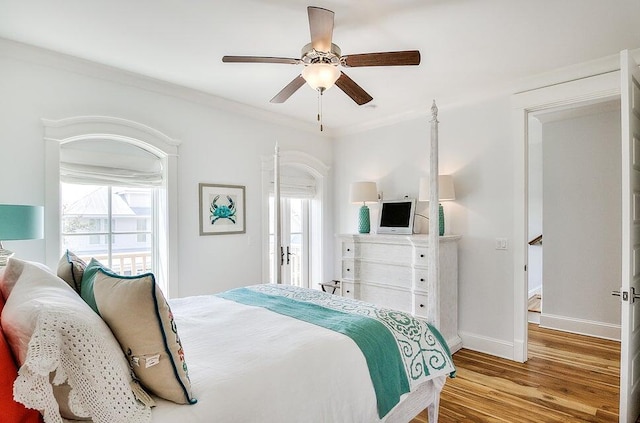 bedroom with ceiling fan, ornamental molding, and light hardwood / wood-style flooring