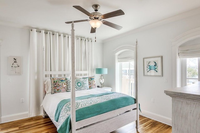 bedroom with ceiling fan, wood-type flooring, and crown molding