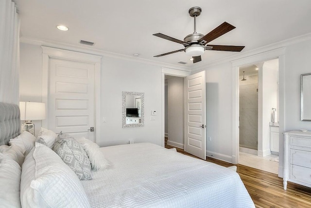 bedroom featuring connected bathroom, ceiling fan, hardwood / wood-style floors, and crown molding