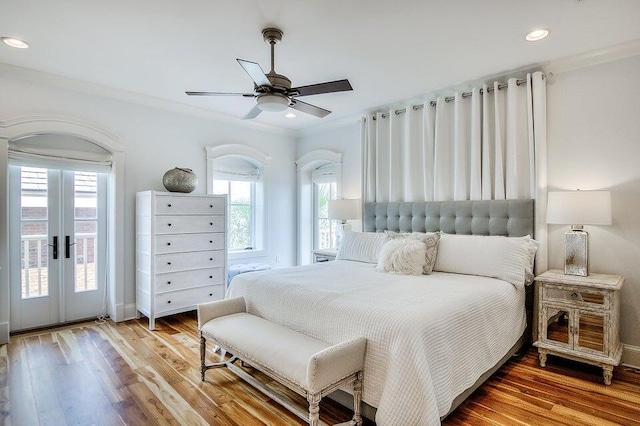 bedroom featuring french doors, access to outside, ceiling fan, crown molding, and wood-type flooring