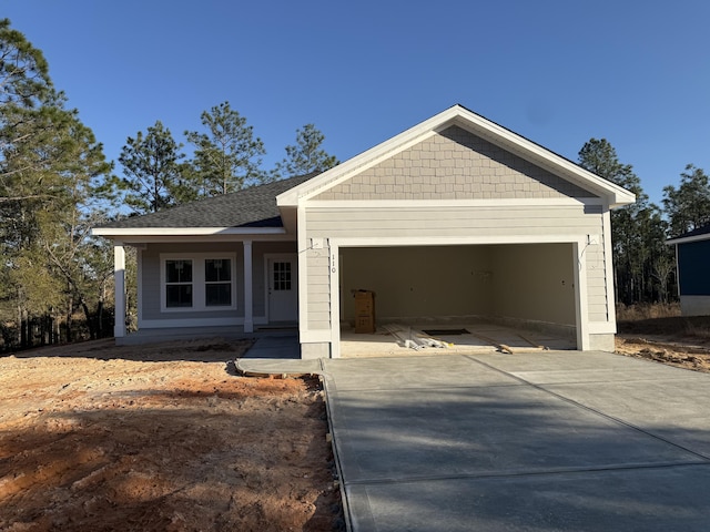 view of front of home featuring a porch and a garage