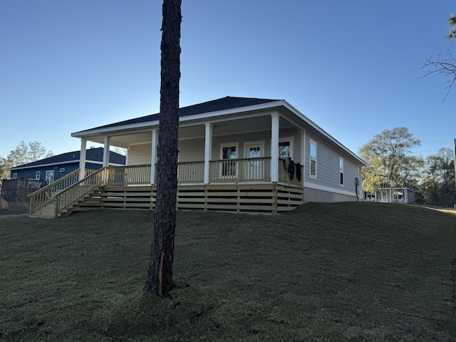 view of front of property with a porch, a front yard, and stairway