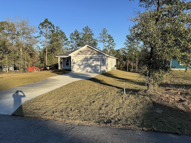 view of side of home featuring driveway, an attached garage, and a lawn