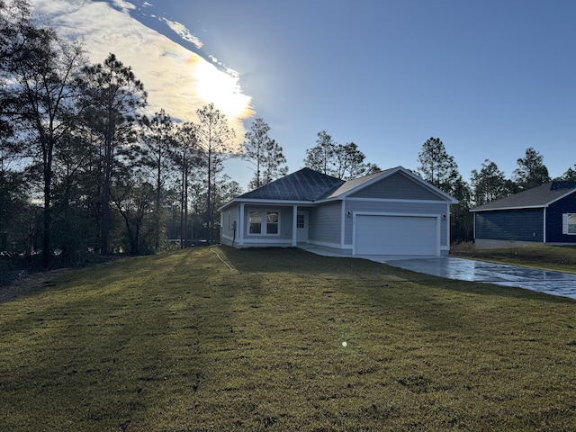 ranch-style home with an attached garage, a front lawn, and concrete driveway