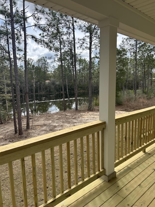 wooden terrace featuring a water view