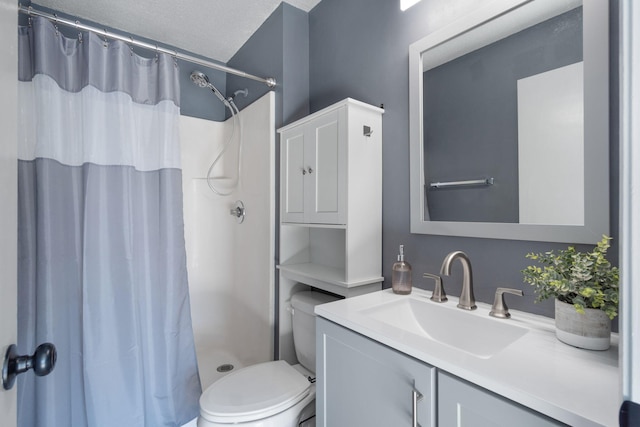 bathroom featuring vanity, a textured ceiling, toilet, and curtained shower