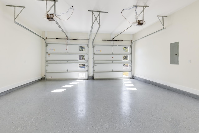 garage with a garage door opener and electric panel