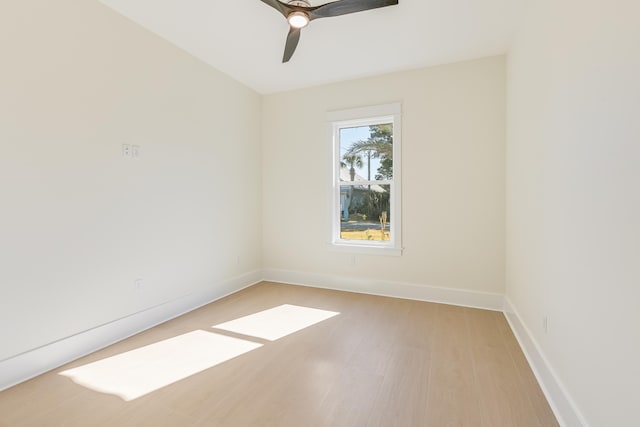 spare room with ceiling fan and light wood-type flooring