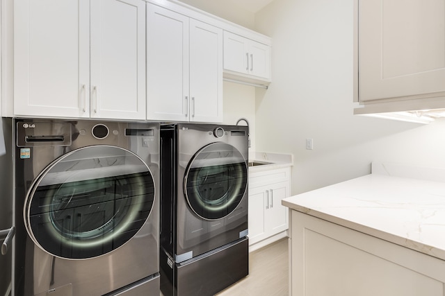 laundry area with cabinets and independent washer and dryer