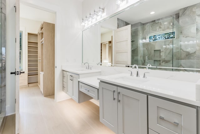 bathroom featuring vanity, an enclosed shower, and tile patterned flooring