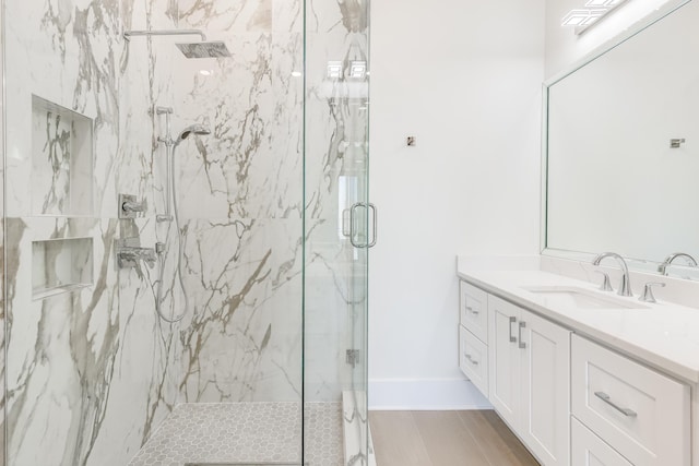 bathroom with vanity, wood-type flooring, and an enclosed shower