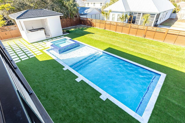 view of swimming pool with an outdoor kitchen, a lawn, a patio area, and an in ground hot tub