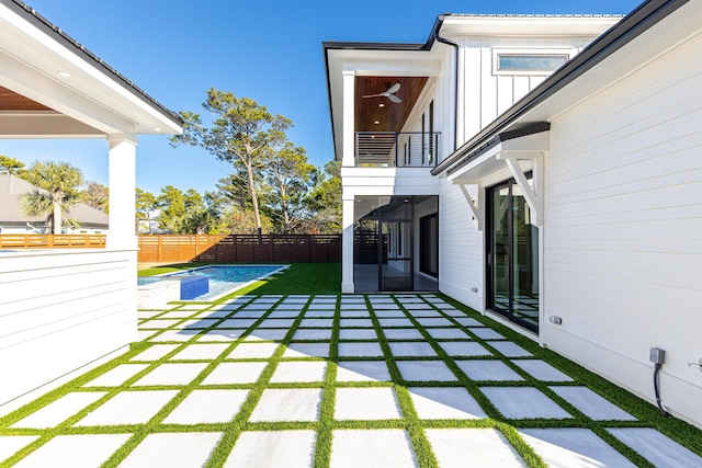 view of yard featuring a fenced in pool and a patio