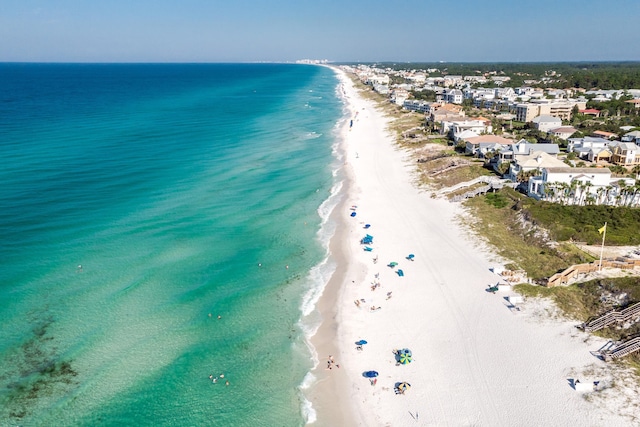 drone / aerial view featuring a water view and a beach view