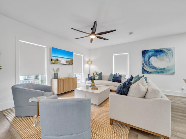 living room with light wood-type flooring and ceiling fan