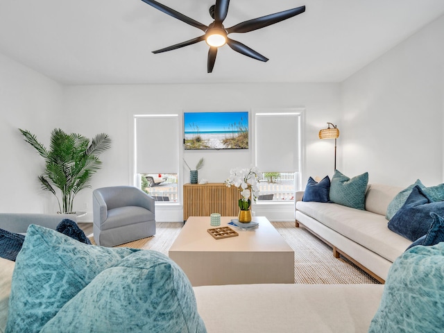 living room featuring ceiling fan and light hardwood / wood-style floors