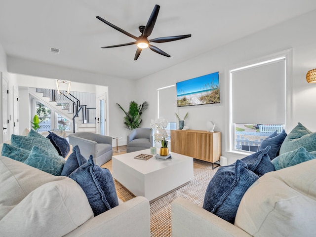 living room with a wealth of natural light, wood-type flooring, and ceiling fan