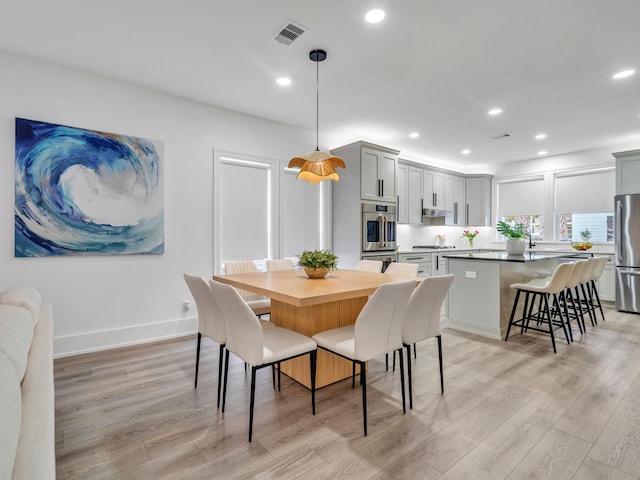 dining space featuring light wood-type flooring