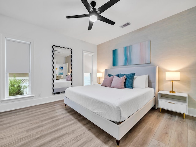 bedroom with light wood-type flooring and ceiling fan