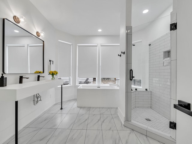 bathroom featuring shower with separate bathtub