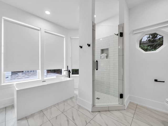 bathroom featuring toilet and independent shower and bath