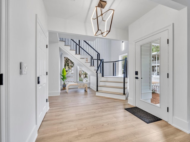 entrance foyer featuring light hardwood / wood-style flooring and an inviting chandelier