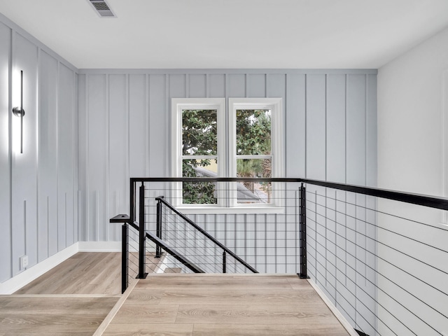 staircase with hardwood / wood-style floors