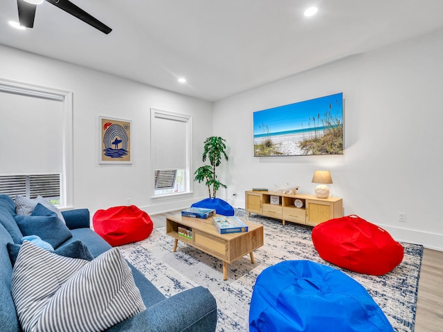 living room with hardwood / wood-style floors and ceiling fan