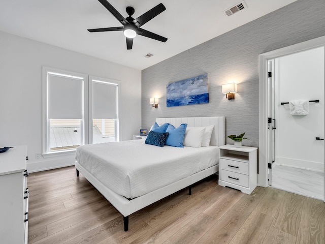 bedroom with light wood-type flooring and ceiling fan