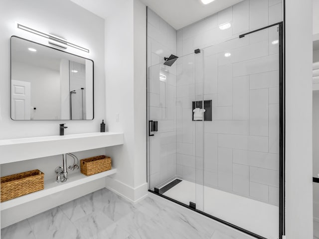 bathroom with a shower with door