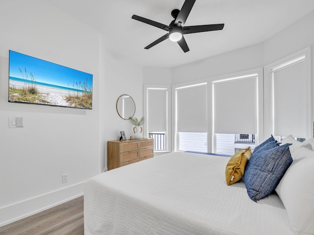 bedroom with hardwood / wood-style floors and ceiling fan