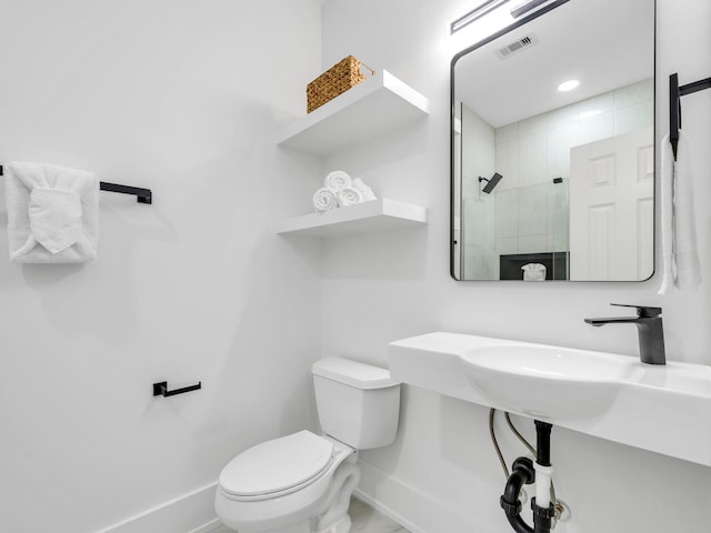 bathroom with toilet and a shower with shower door