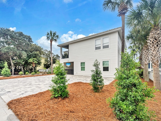 rear view of property featuring a garage