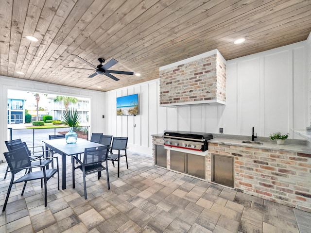 view of patio / terrace featuring grilling area, ceiling fan, sink, and exterior kitchen