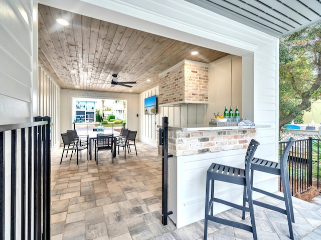 view of patio / terrace featuring exterior bar and ceiling fan