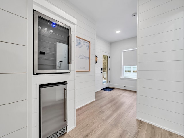 corridor featuring wine cooler and light wood-type flooring