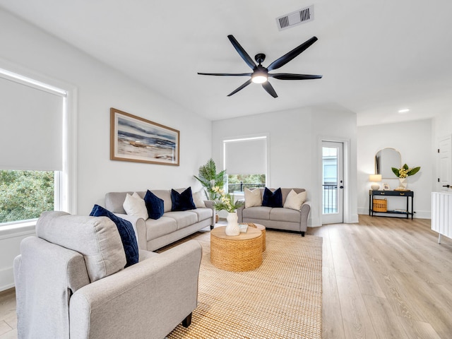 living room with ceiling fan and light hardwood / wood-style floors