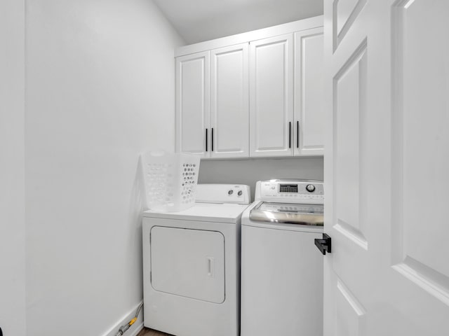 laundry room featuring cabinets and washing machine and clothes dryer