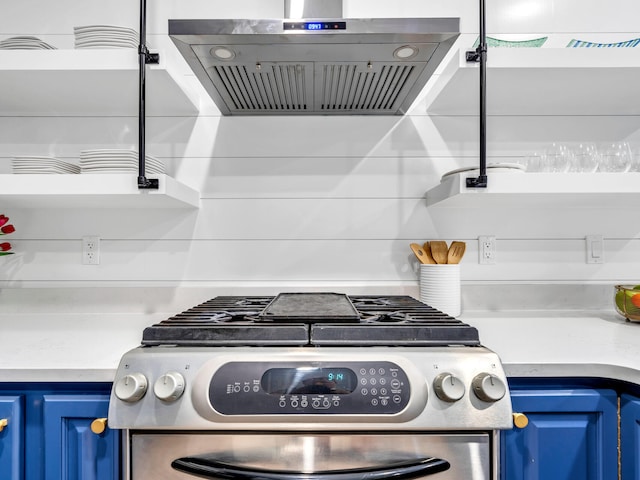 kitchen with range hood, blue cabinetry, and stainless steel range with gas cooktop