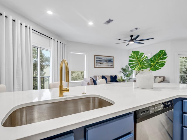 kitchen with dishwasher, blue cabinets, sink, and ceiling fan