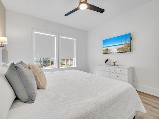 bedroom with light hardwood / wood-style flooring and ceiling fan