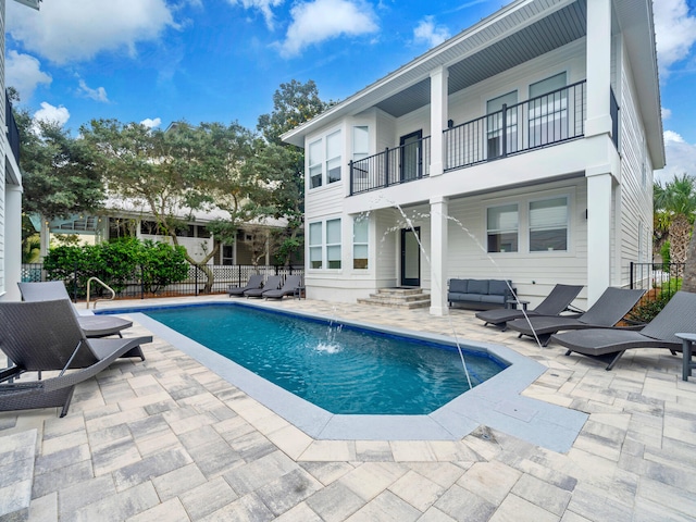 view of pool with a patio and pool water feature