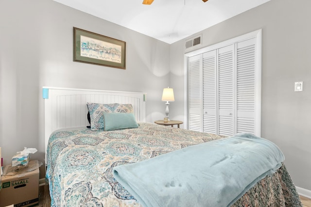 bedroom featuring hardwood / wood-style flooring, ceiling fan, and a closet