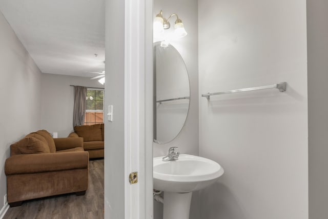 bathroom featuring hardwood / wood-style flooring, ceiling fan, and sink