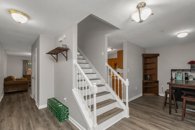 stairs with hardwood / wood-style floors and a textured ceiling